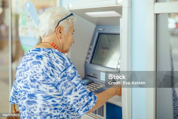 Using The Atm Stock Photo - Download Image Now - ATM, Currency, 70-79 Years