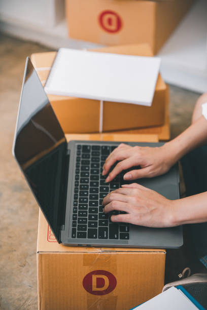 istock Small start-up business owners checking parcels at work, freelancers, salespeople, checking production orders. Pack products for delivery to customers Sell 