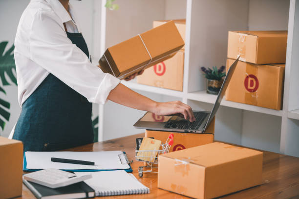 istock Small start-up business owners checking parcels at work, freelancers, salespeople, checking production orders. Pack products for delivery to customers Sell 