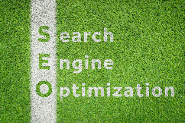 Search Engine Optimization (SEO) word on green artificial grass football (soccer) field textured background with white line. Digital marketing, business term, sign and symbol concept.