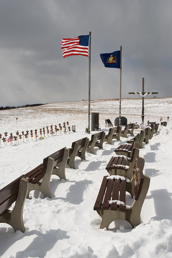 Flight 93 plane crash site memorial, the 911 terrorist attack on America 2001 and the start of the war on terrorism, flags flying in strong winter breeze, Shanksville, Pennsylvania, PA, USA.