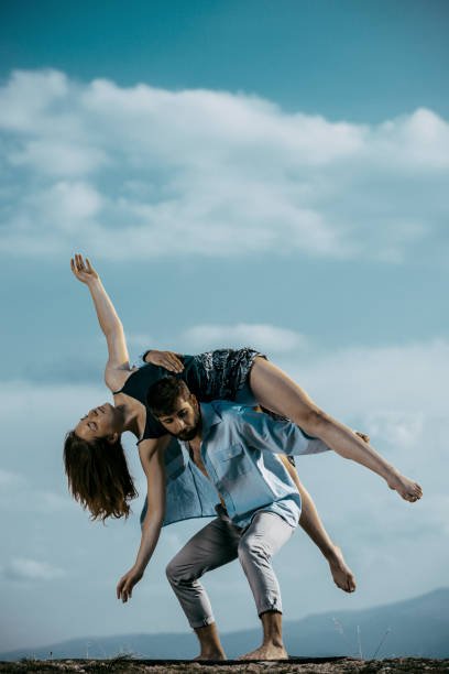 istock Happy romantic couple dancing open air under blue sky 1367015496