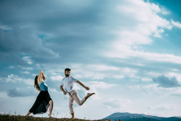 istock Beauty couple dancing social dance over sky with clouds 1367015502