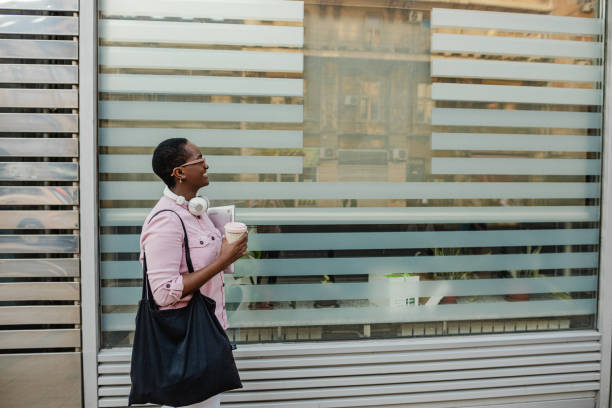 istock Side view on young African-American woman walks 1367016779