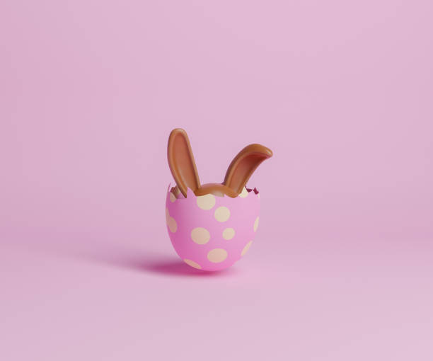 œuf de pâques cassé avec des oreilles de lapin en chocolat qui sortent - oeuf de pâques photos et images de collection