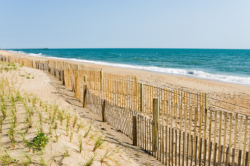 Beach fences and surf, Atlantic Ocean horizon on a summer morning at the beach, Outer Banks in North Carolina, NC, USA.
