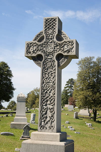 istock Celtic Cross in Stone, Cemetery Sunlight 136702088