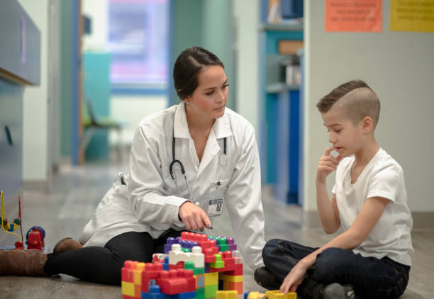 istock Occupational Therapist Sitting With a Child 1367021545