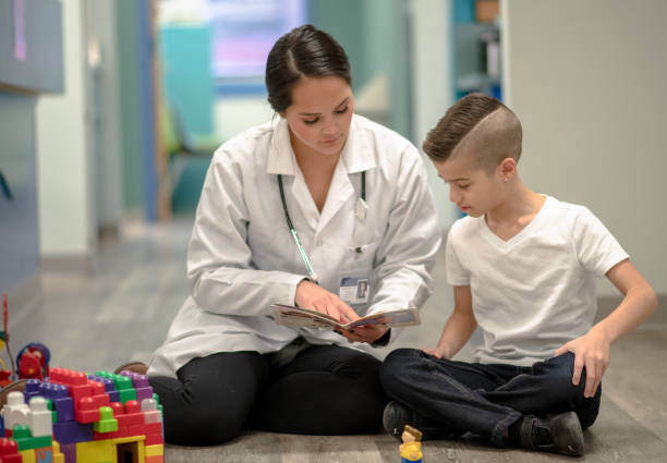 istock Speech Therapist Sitting With a Child 1367021548
