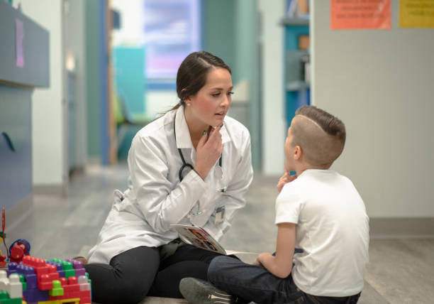 istock Speech Therapist Sitting With a Child 1367021552