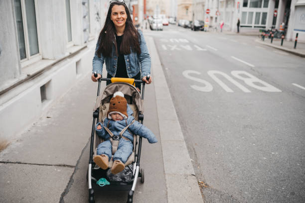 istock Mother pushing a stroller in the street 1367022773