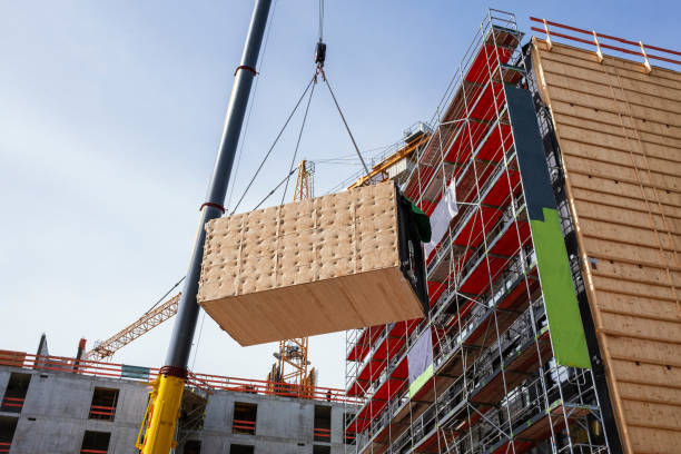 istock Crane lifting a wooden building module to its position in the structure. 1367025285