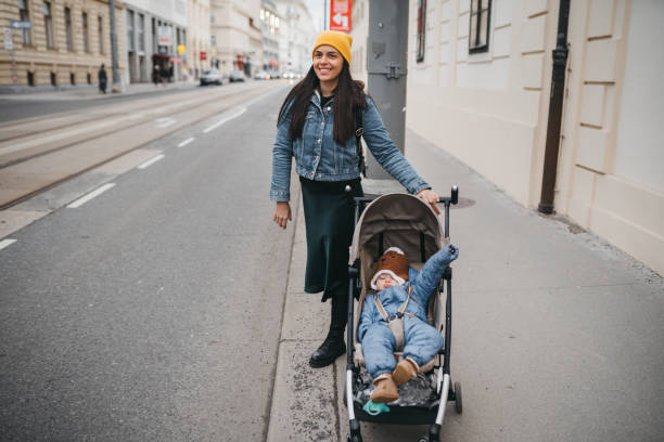 istock Mother pushing a stroller in the street 1367025586