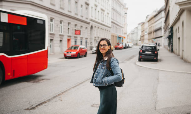 istock A woman is waiting for a bus at a stop 1367025979