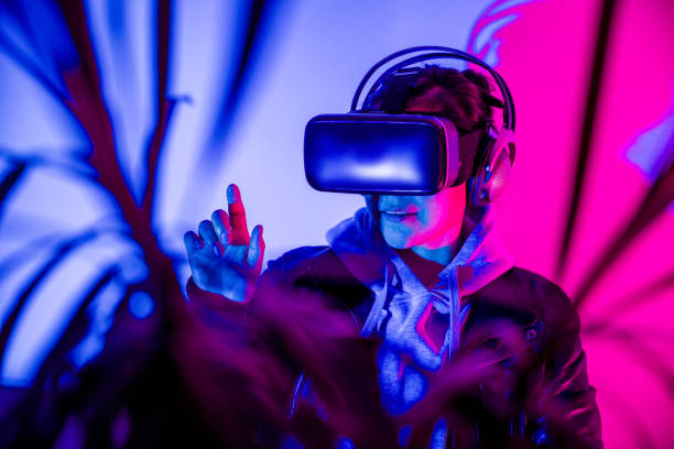 istock Woman interacting in virtual reality with VR glasses, enjoying the metaverse. 1367026011