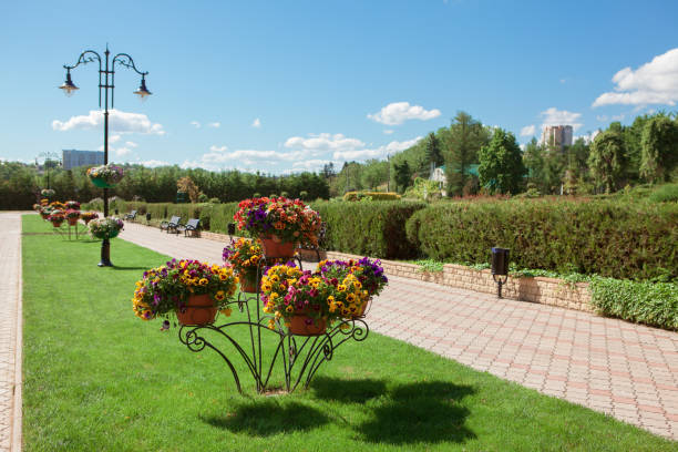 Park with ornamental garden . Sidewalk with pavement . Public park in the spring