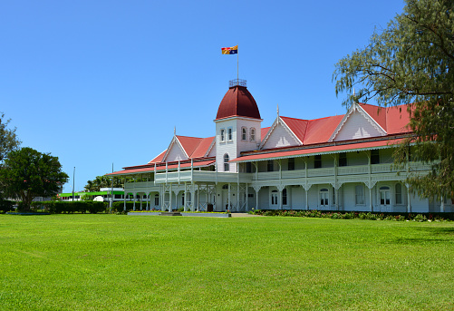 Nuku'alofa, Tongatapu island, Tonga: Royal Palace - wooden Palace, which was built in 1867 in Victorian style - seat of the King of Tonga, a constitutional monarchy - royal flag in the central tower flanked by the side wings.