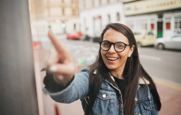 istock A woman is waiting for a bus at a stop 1367028016