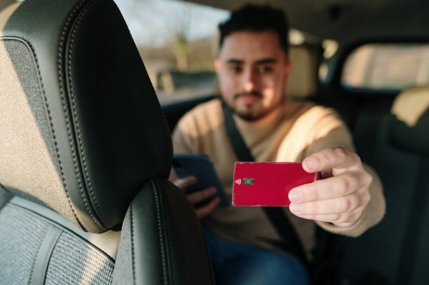 istock Paying a taxi with credit card 1367028518