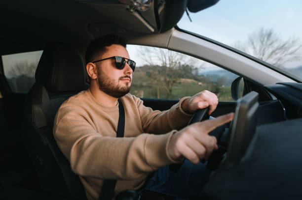 istock Touching a touch screen of a car 1367028711