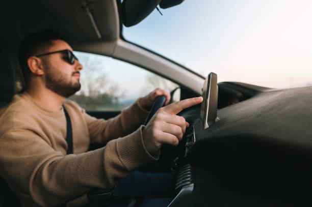 istock Touching a touch screen of a car 1367028712