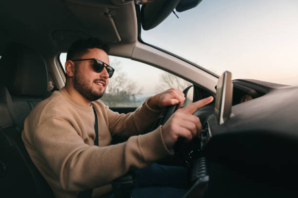 istock Touching a touch screen of a car 1367028742