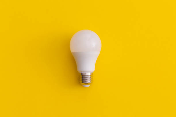 istock Light bulb on yellow background. Inspiration and creative idea concept. 1367029776