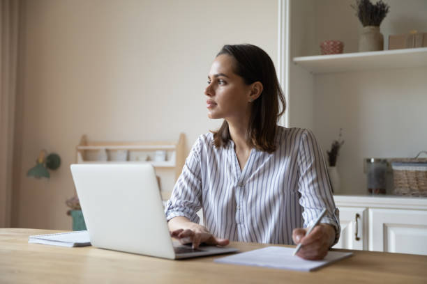 istock Thoughtful young business professional lost in deep thoughts at workplace 1367030465