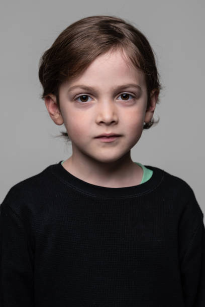 istock little schoolboy looking at the camera 1367033354
