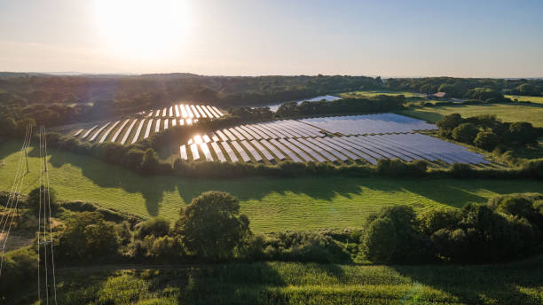 Aerial view of the solar panel in solar farm in evening sun light. Aerial view of the solar panel in solar farm in evening sun light, West Sussex, UK. solar powered station stock pictures, royalty-free photos & images