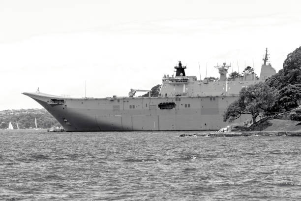 Rio de Janeiro, Brazil - August 24, 2018: Warship patrols the coast of Rio de Janeiro (Brazil) while a tourist watches