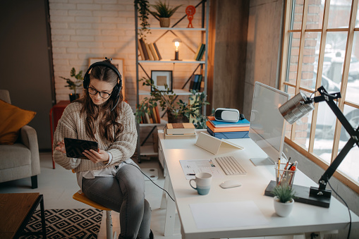 Photo of a woman working online from home office