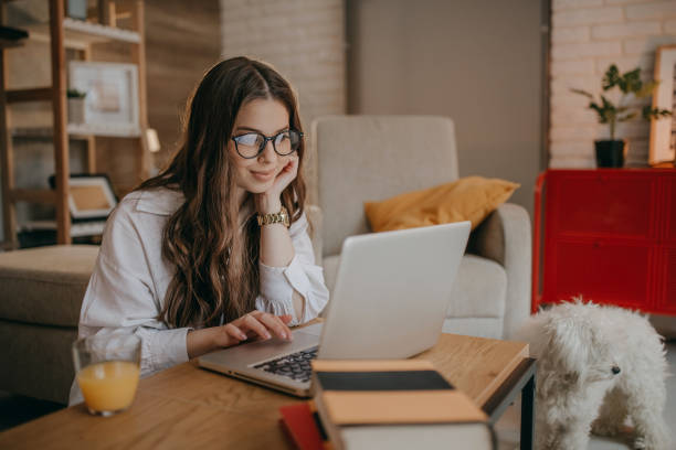 istock Young woman using laptop at home 1367039203