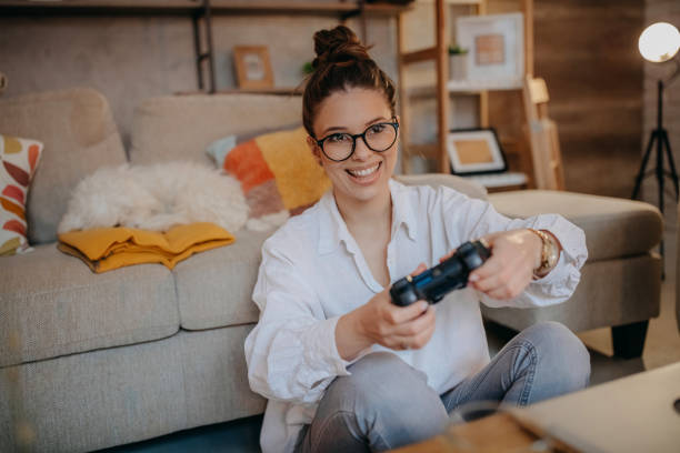 istock Woman playing video games 1367039222