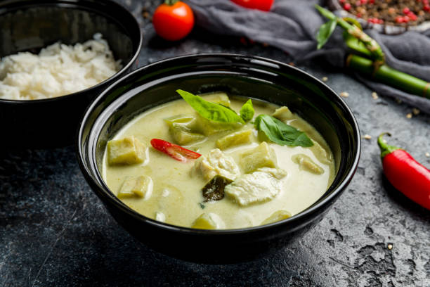 istock green Chinese soup on black bowl on dark stone table 1367040517