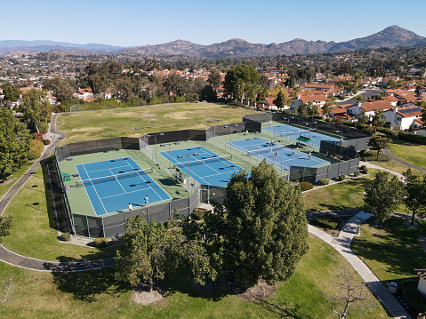 Aerial view over tennis courts in small community park in the suburb of San Diego in South of Rancho Bernardo, South California, USA. January 22nd, 2022