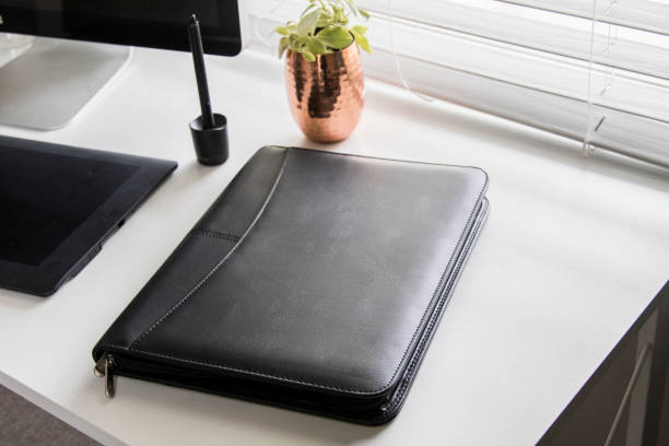 istock Black leather business padfolio portfolio folder on desk 1367041701