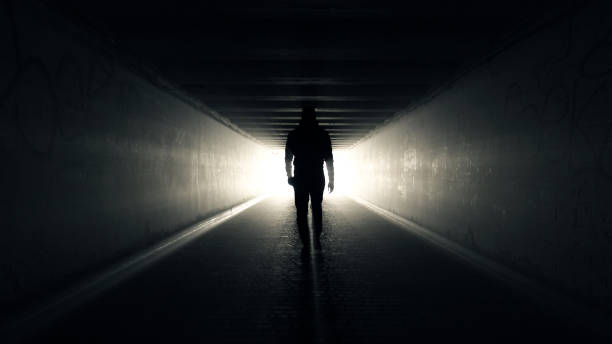 istock Man walking in Tunnel to the Light 1367042011