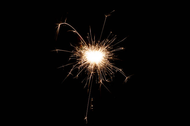 istock Burning sparkler isolated on black background. Fireworks theme. Light effect and texture. 1367046984