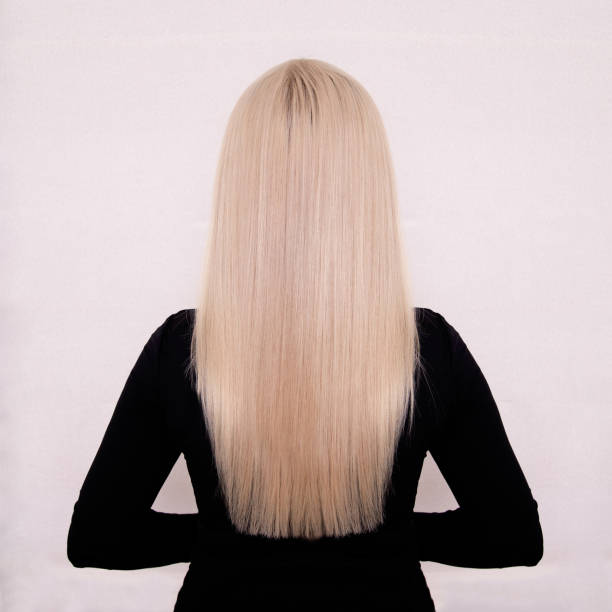 istock Female back with long, straight, blonde hair 1367047366