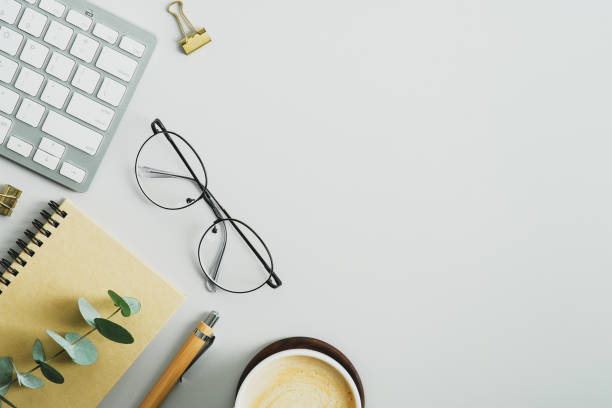 istock Elegant feminine workspace with office supplies, eucalyptus branches, coffee cup, keyboard, glasses on pastel green background. Modern office desk table, blogger workplace. 1367048355
