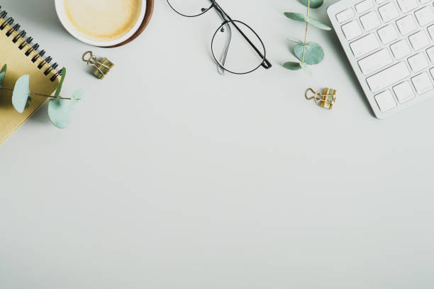 istock Flat lay, top view office table desk. Workspace with cup of coffee, keyboard, glasses, paper notebook on green background. Feminine workspace, minimalist style, business concept 1367048364