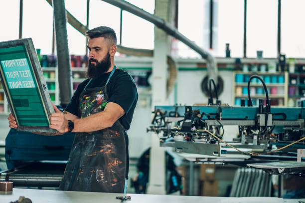 istock Male worker preparing screen printing film in a workshop 1367048651