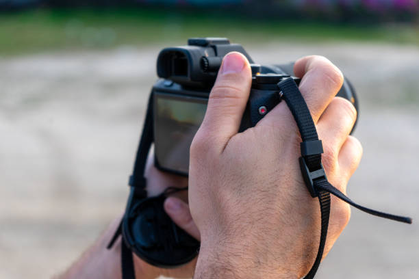Person handling a reflex camera. taking a picture