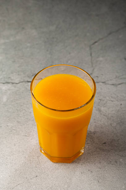 istock Mango juice in glass cup on the table. Mango smoothie. 1367053178