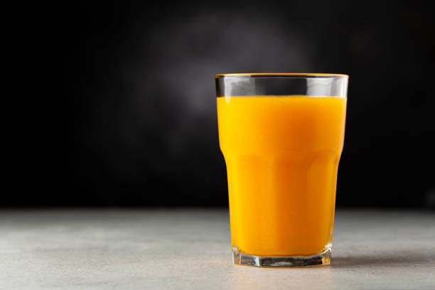 istock Mango juice in glass cup on the table. Mango smoothie. 1367053181