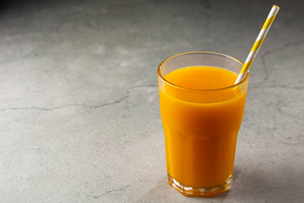 istock Mango juice in glass cup on the table. Mango smoothie. 1367053185