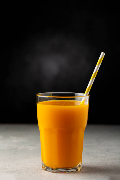 istock Mango juice in glass cup on the table. Mango smoothie. 1367053190