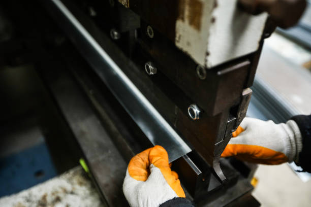 istock Worker At Machine Bending Metal Plates In Steel Mill 1367053321