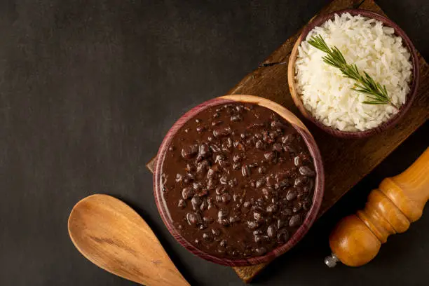 Black beans and rice in wooden bowl.